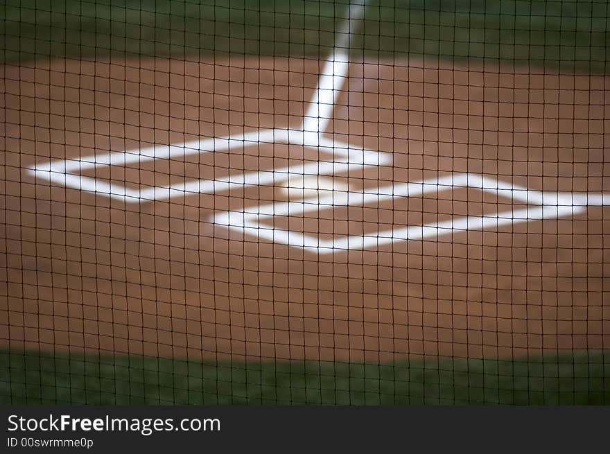 Looking through the backstop at home plate. Looking through the backstop at home plate