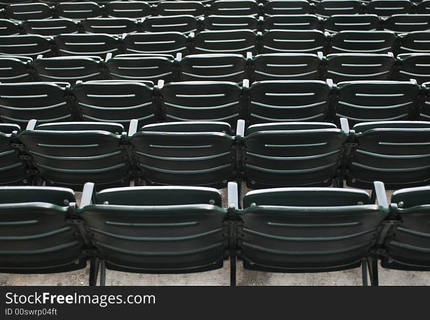 Looking at green stadium seats at the ball park. Looking at green stadium seats at the ball park