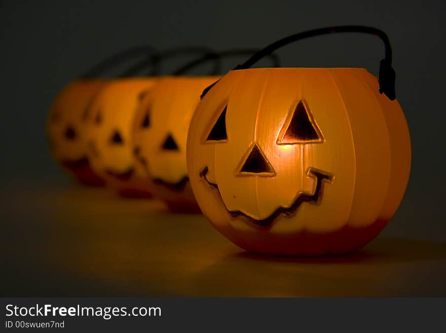 Horizontal image of lit jack-o-lanterns. Horizontal image of lit jack-o-lanterns