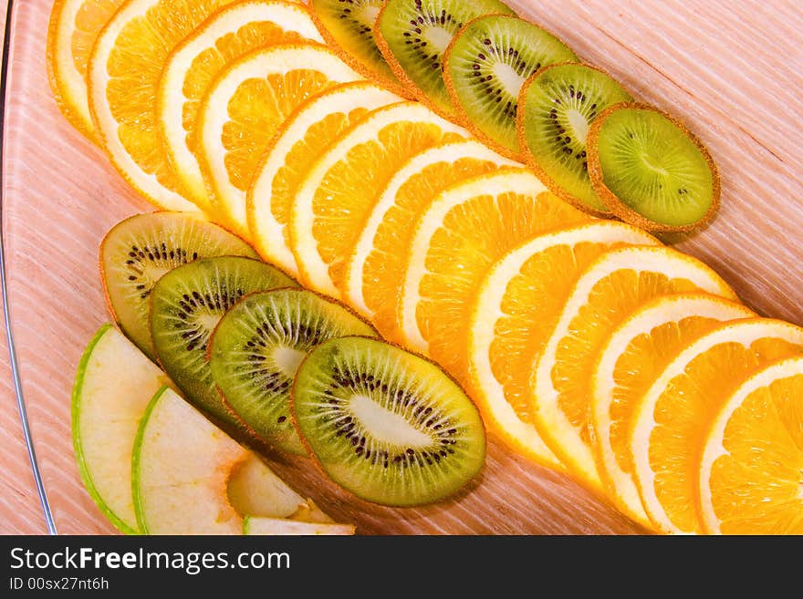 Apple, orange and kiwi on table. Apple, orange and kiwi on table