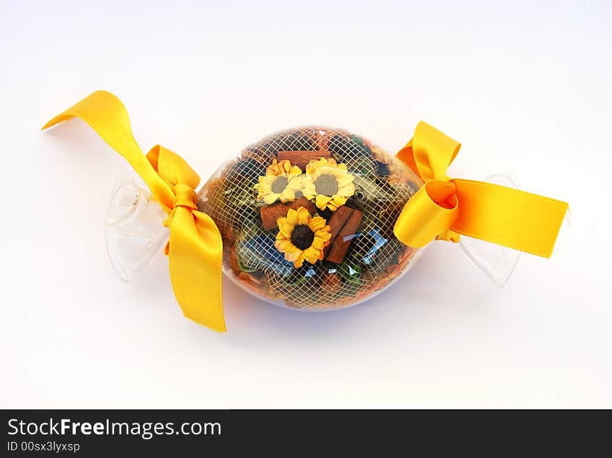 A glass sweet filled with flowers and yellow narrow