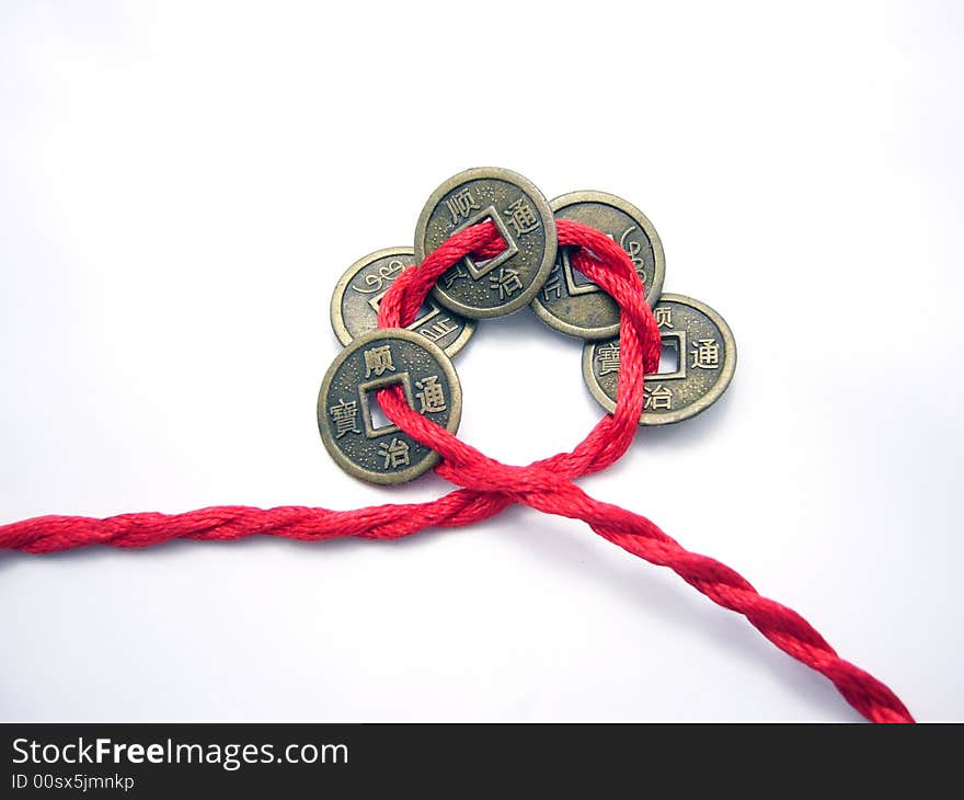 Five chinese ancient coins chained with a red cord