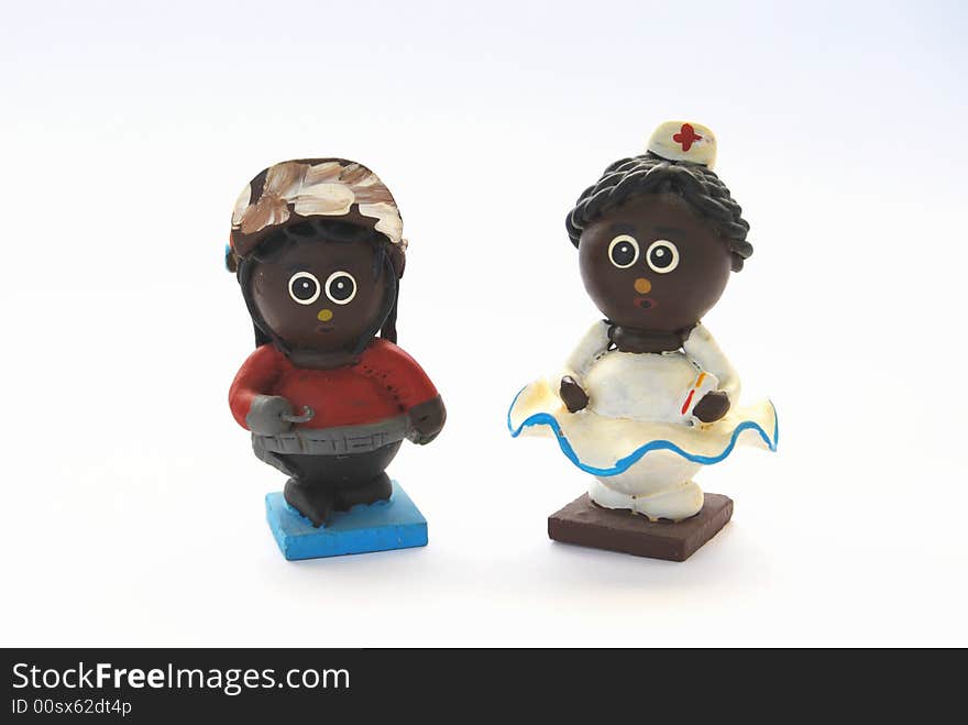 Two black clay dolls: a nurse and a hook man. Two black clay dolls: a nurse and a hook man