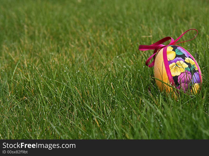 Hand crafted colorful easter eggs in a green meadow. Hand crafted colorful easter eggs in a green meadow