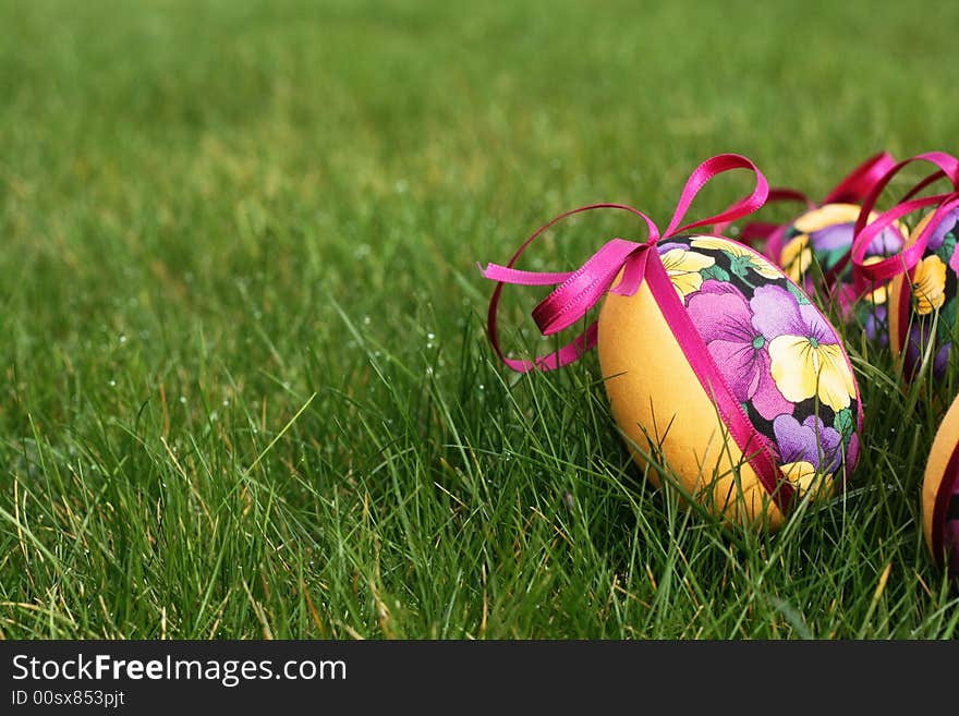 Hand crafted colorful easter eggs in a green meadow. Hand crafted colorful easter eggs in a green meadow