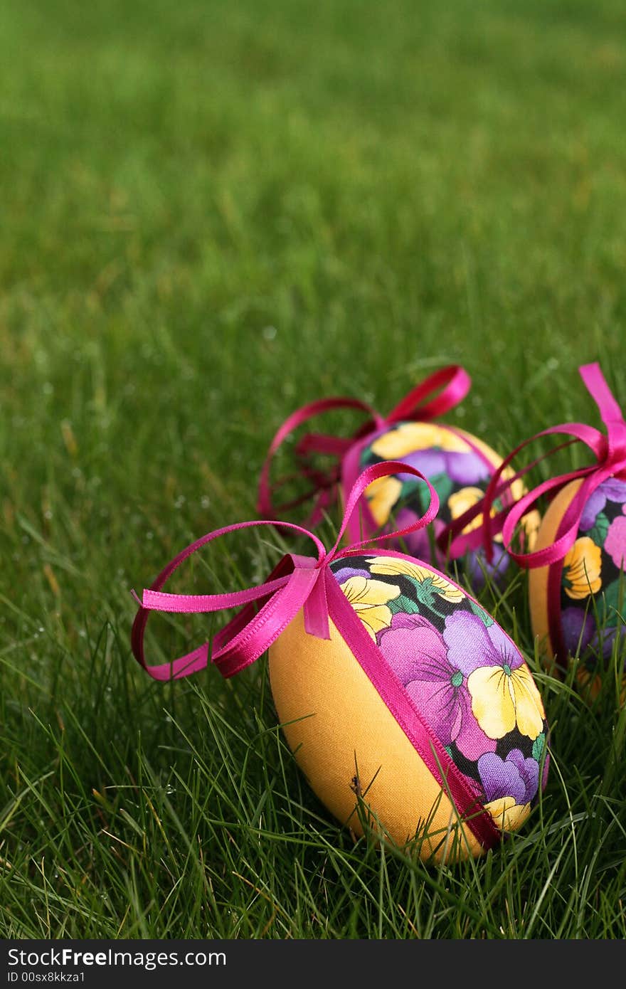 Hand crafted colorful easter eggs in a green meadow. Hand crafted colorful easter eggs in a green meadow