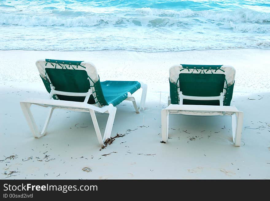 Beach green chairs in a  cancun beach