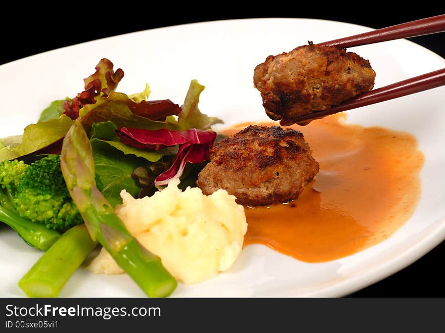 Delicious Asian Kobe beef meatballs with mashed potatoes and salad. Delicious Asian Kobe beef meatballs with mashed potatoes and salad