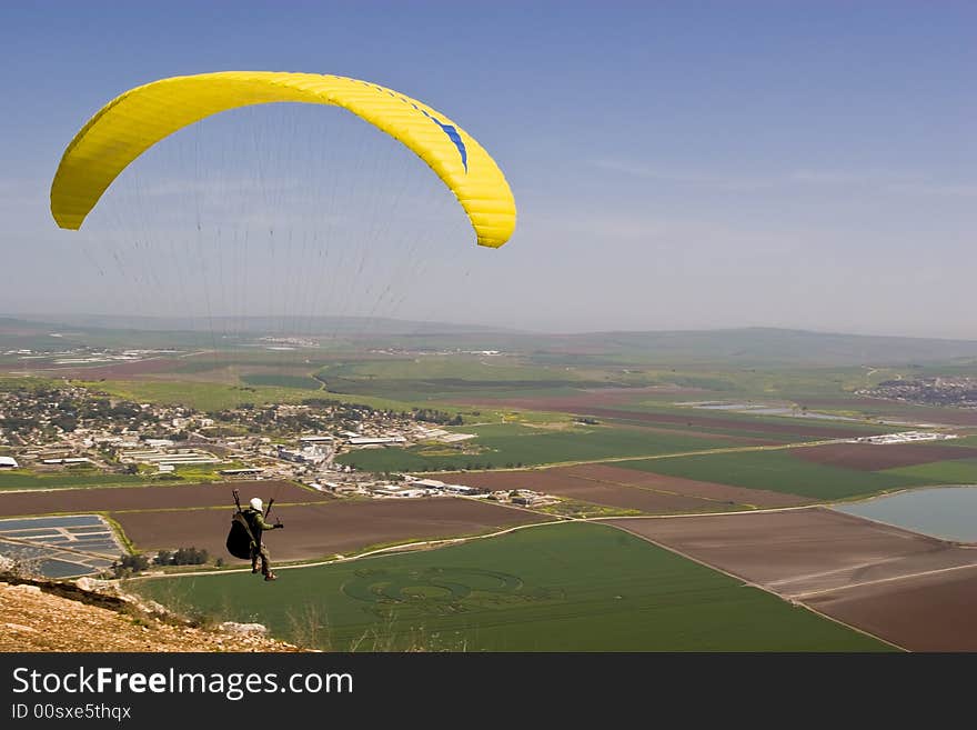 Parachutist just run from a cliff for gliding with a free fall parachute.