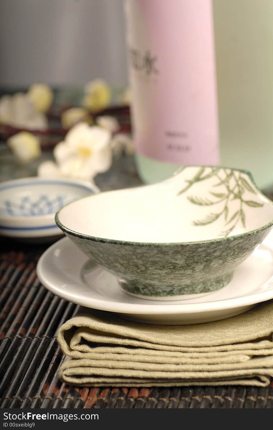 Asian restaurant table setup with sake and flowers