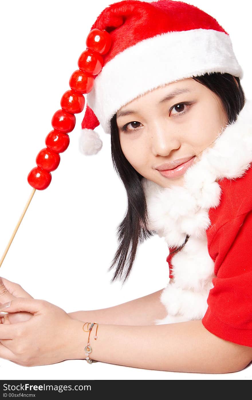 Beautiful asian Santa Claus girl smiling and holding holding traditional food Tanghulu isolated on white. Beautiful asian Santa Claus girl smiling and holding holding traditional food Tanghulu isolated on white