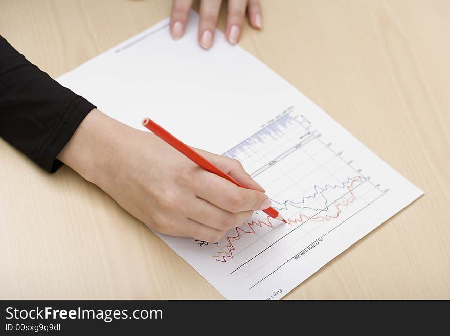 Woman drawing a graph with a red pencil