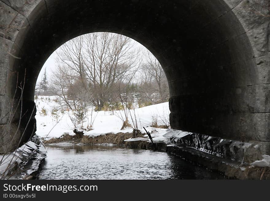 Through Bridge. A nice picture lloking through a tunnel to view the scenery in the background. The Tunnel acts as of frame for the landscape in the background