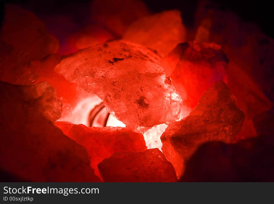 Red coloured stones coals in the light close up