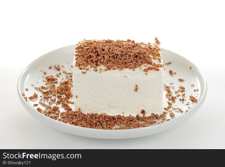 The milk icecream with grated brown chocolate on the white plate