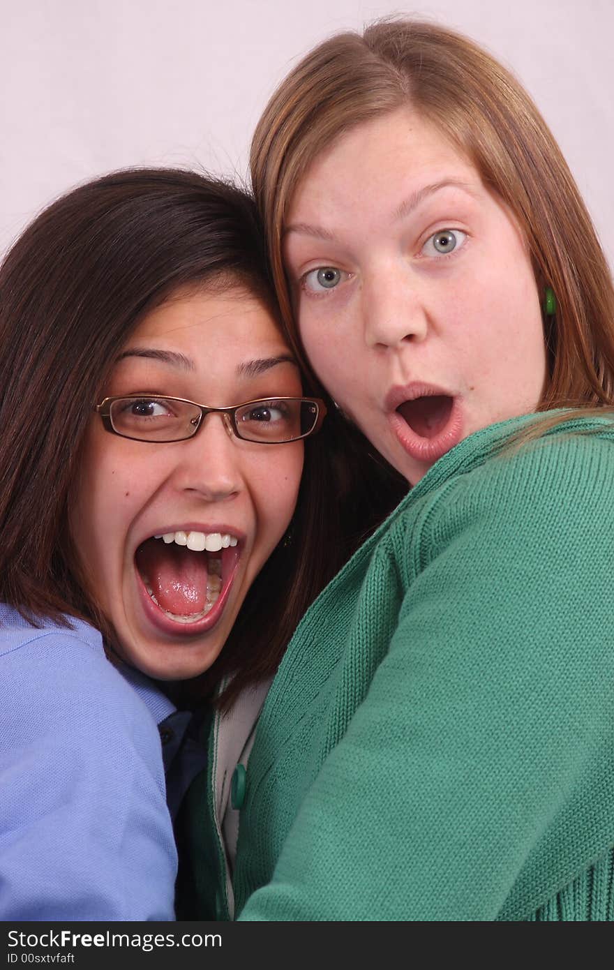 Close-up of two young women making silly faces. Close-up of two young women making silly faces