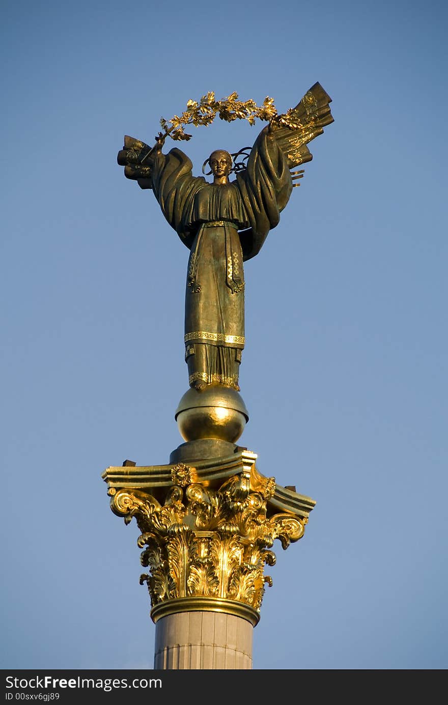 This is a statue of an angel, made of copper, and gold plated, standing on a tall pillar, in the center of Kiev, Ukraine. This is a statue of an angel, made of copper, and gold plated, standing on a tall pillar, in the center of Kiev, Ukraine.