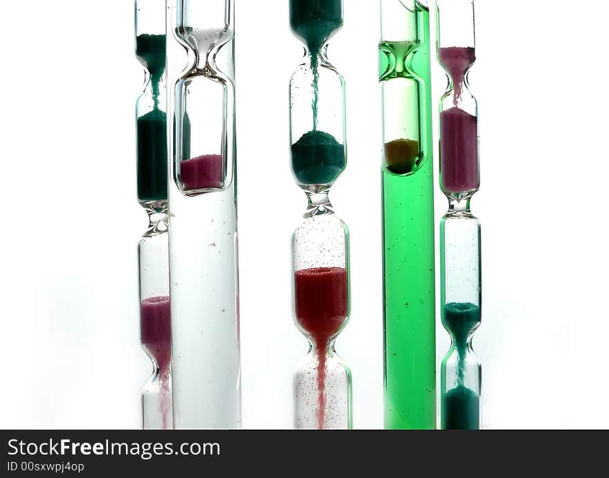 Colorful hourglasses on white background