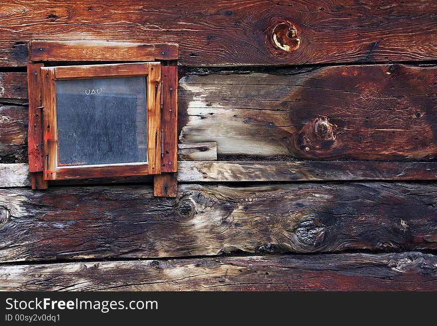 closed window on an old wooden wall. closed window on an old wooden wall