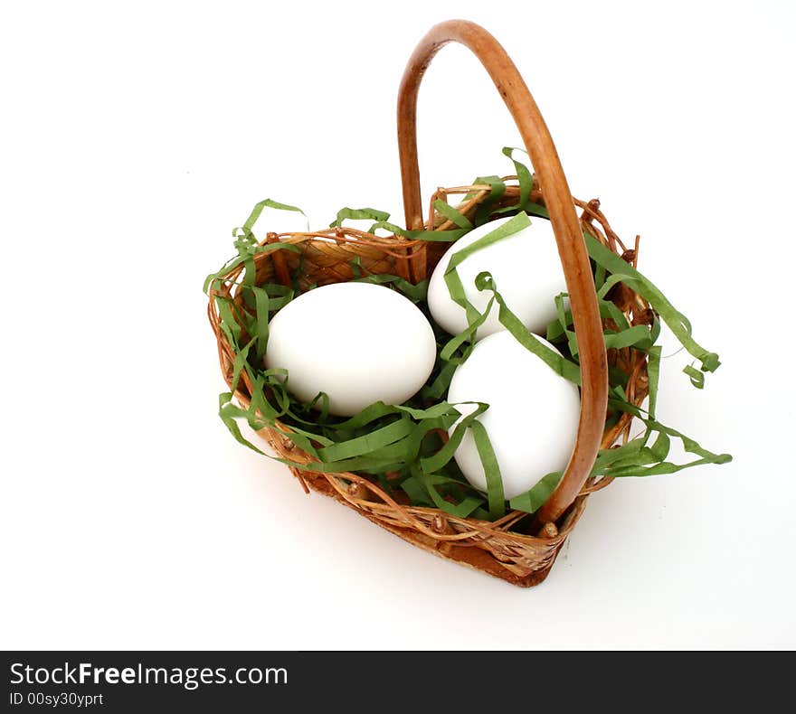 Three eggs in a basket in form of heart