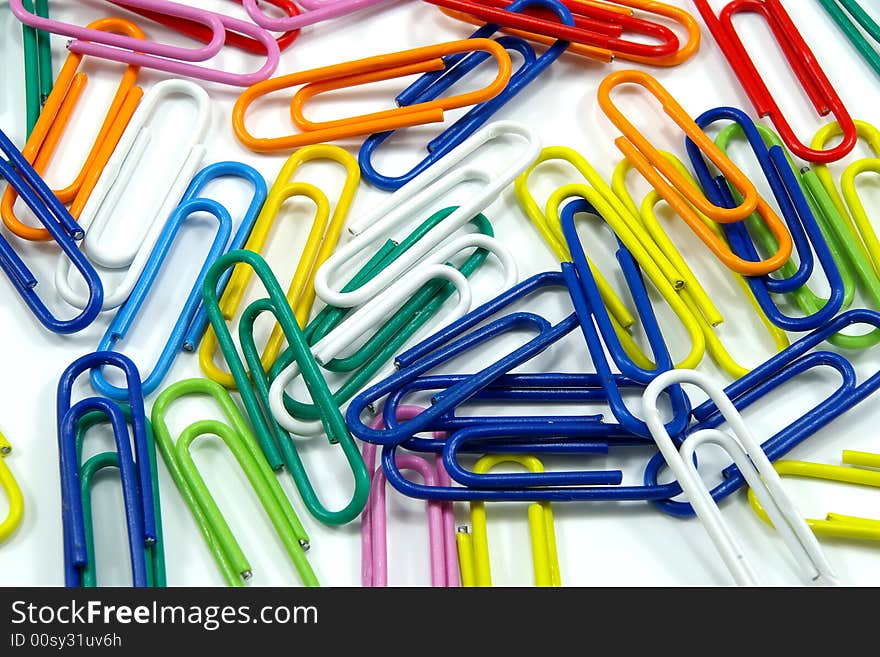 Close view of milti-colored paper clips on white background