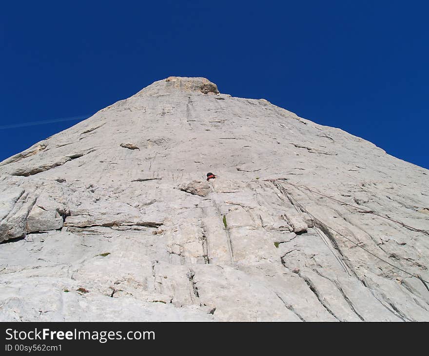 Climber leads first pitch on east face of Picu Urriellu