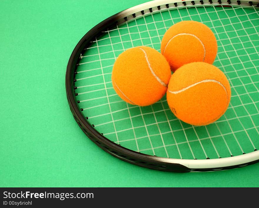 Three tennis balls over a racket