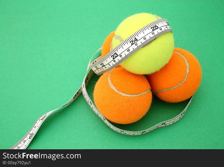 Tape measure wrapped around four tennis balls. Tape measure wrapped around four tennis balls