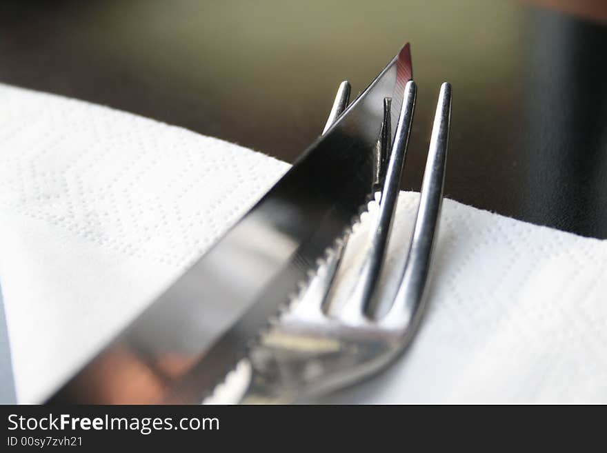 A fork with a knife on the table. A fork with a knife on the table