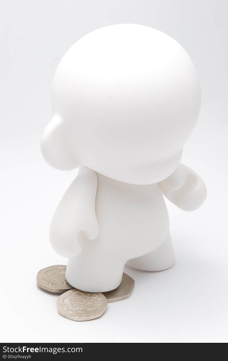 An abstract character standing on coins. An abstract character standing on coins.