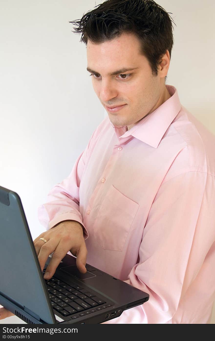 A man, holding a laptop computer, in his hands, smiling. A man, holding a laptop computer, in his hands, smiling