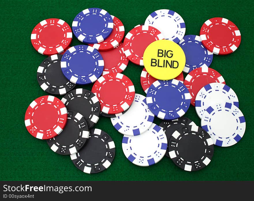 Colorful gambling chips over a green table. Colorful gambling chips over a green table