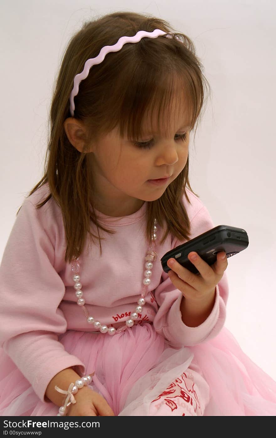 Cute little girl getting a tekst message on her cellphone. Cute little girl getting a tekst message on her cellphone