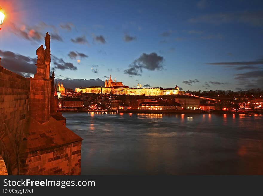 The magnificent Prague Castle at night along the River Vltava