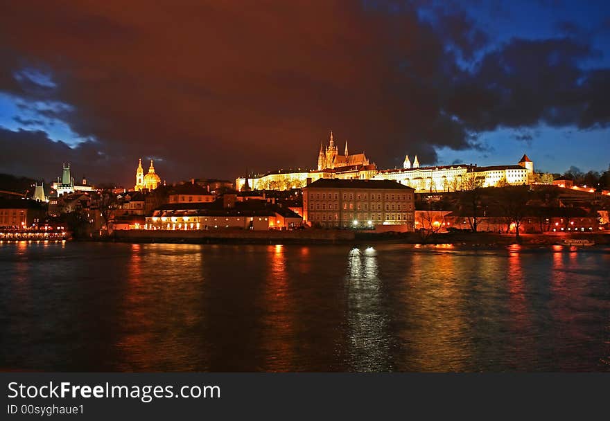 The magnificent Prague Castle at night along the River Vltava