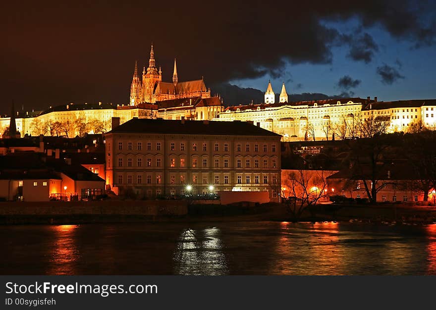 The magnificent Prague Castle at night along the River Vltava