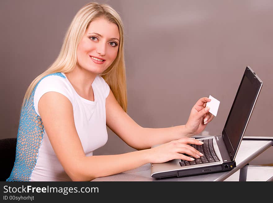 Pretty blond woman working on laptop. Pretty blond woman working on laptop