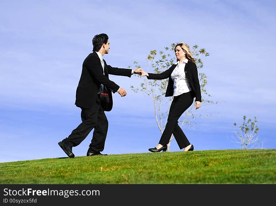 Portrait of a confident and successful business team posing outdoors in a green field