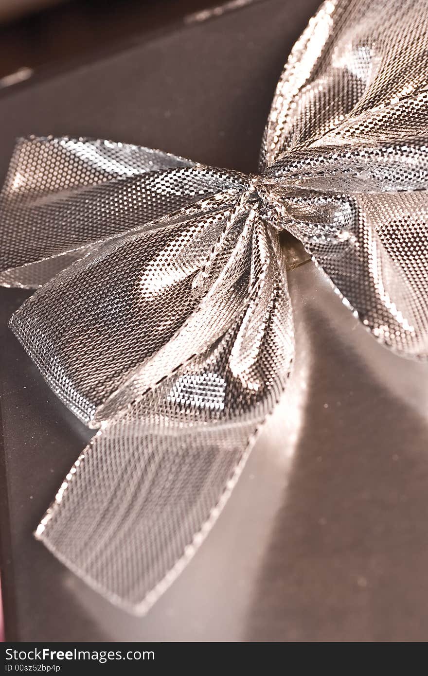 Macro of a silver bow on a box