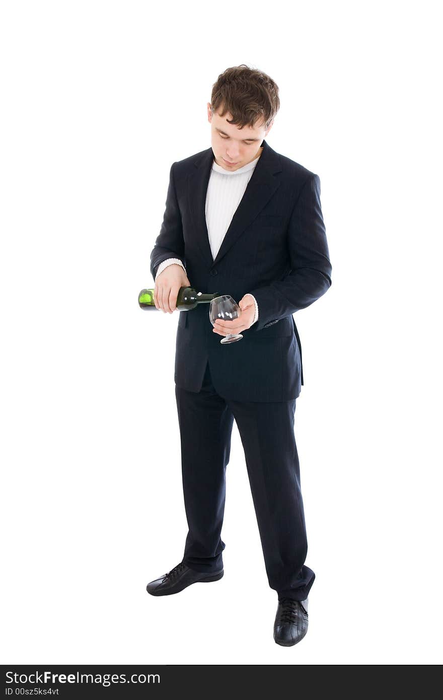 The young businessman with a bottle of wine isolated on a white background. The young businessman with a bottle of wine isolated on a white background