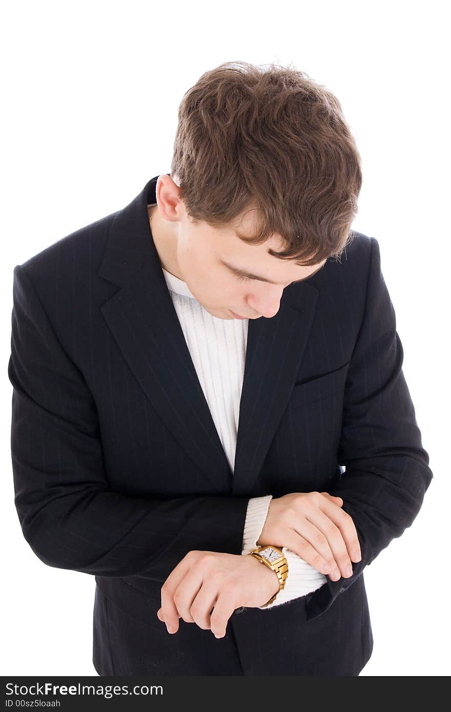 The young businessman looks at a watch isolated on a white background. The young businessman looks at a watch isolated on a white background