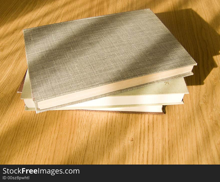 Three old books on desk