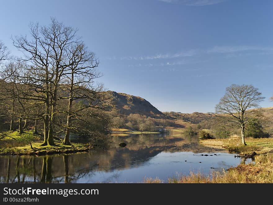 A view of Rydal Water in the English Lake District in early morning sunlight. A view of Rydal Water in the English Lake District in early morning sunlight