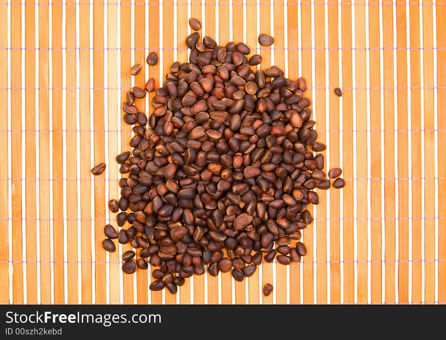 A Pile Of Cedar Nut On Bamboo Table-cloth