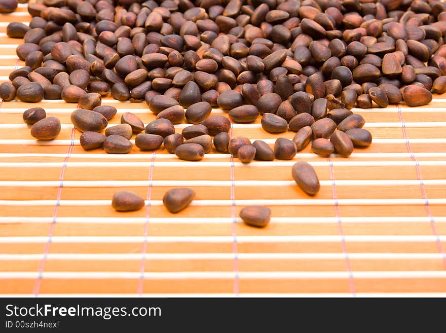 A Pile Of Cedar Nut On Bamboo Table-cloth