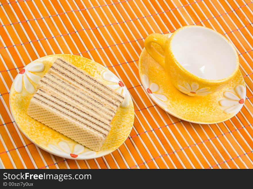 Waffle Slice And Empty Cup On Bamboo Table-cloth