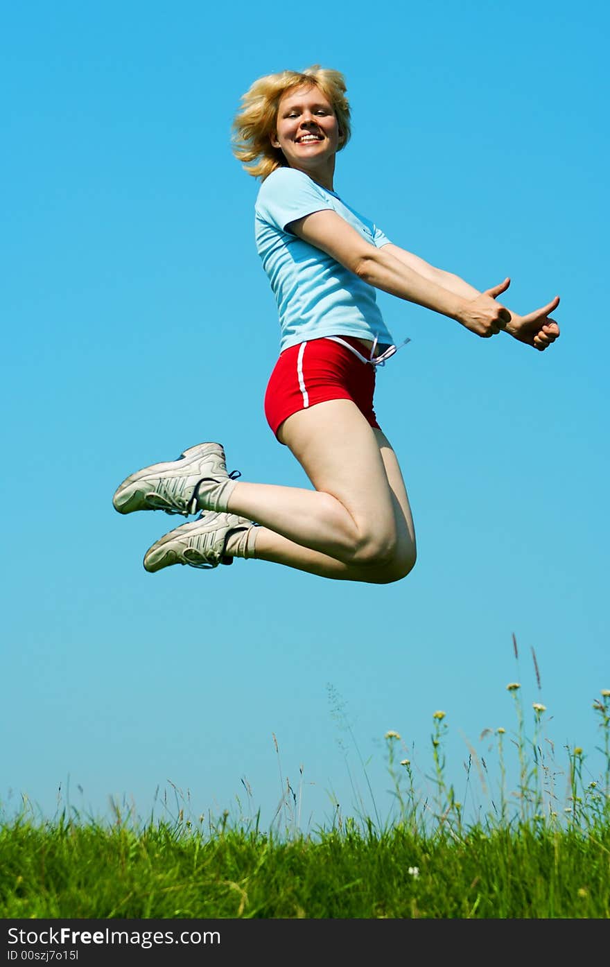 Woman jump outdoor under blue sky