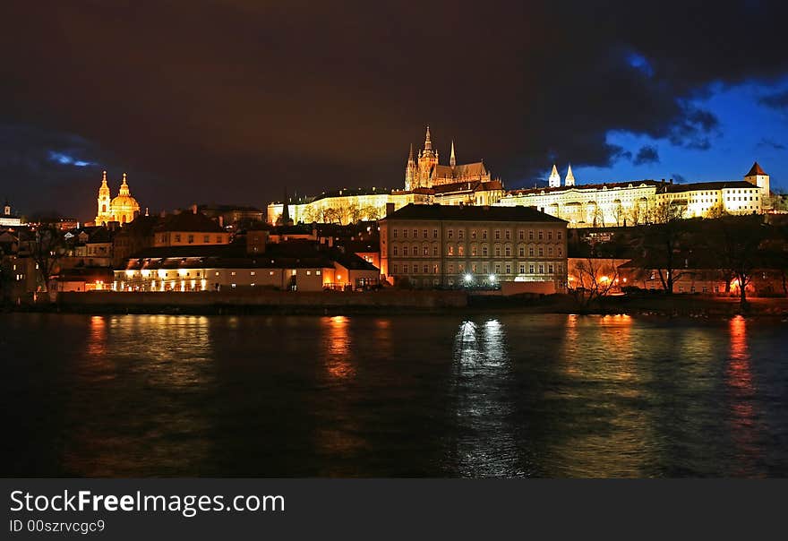 The magnificent Prague Castle at night along the River Vltava