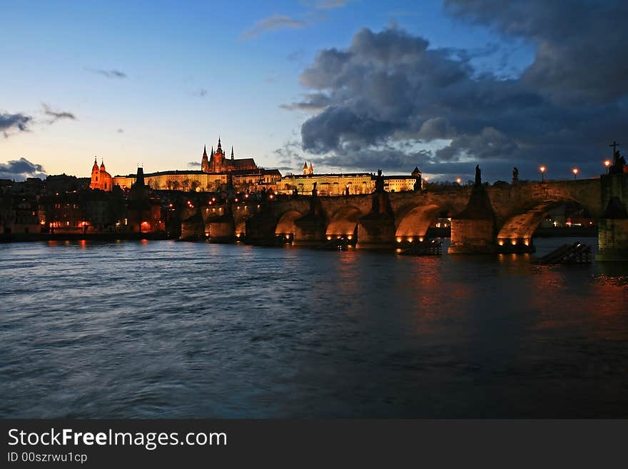 The magnificent Prague Castle at night along the River Vltava