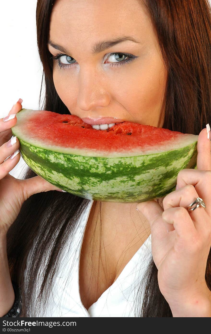 Beautiful brunette eating a melon